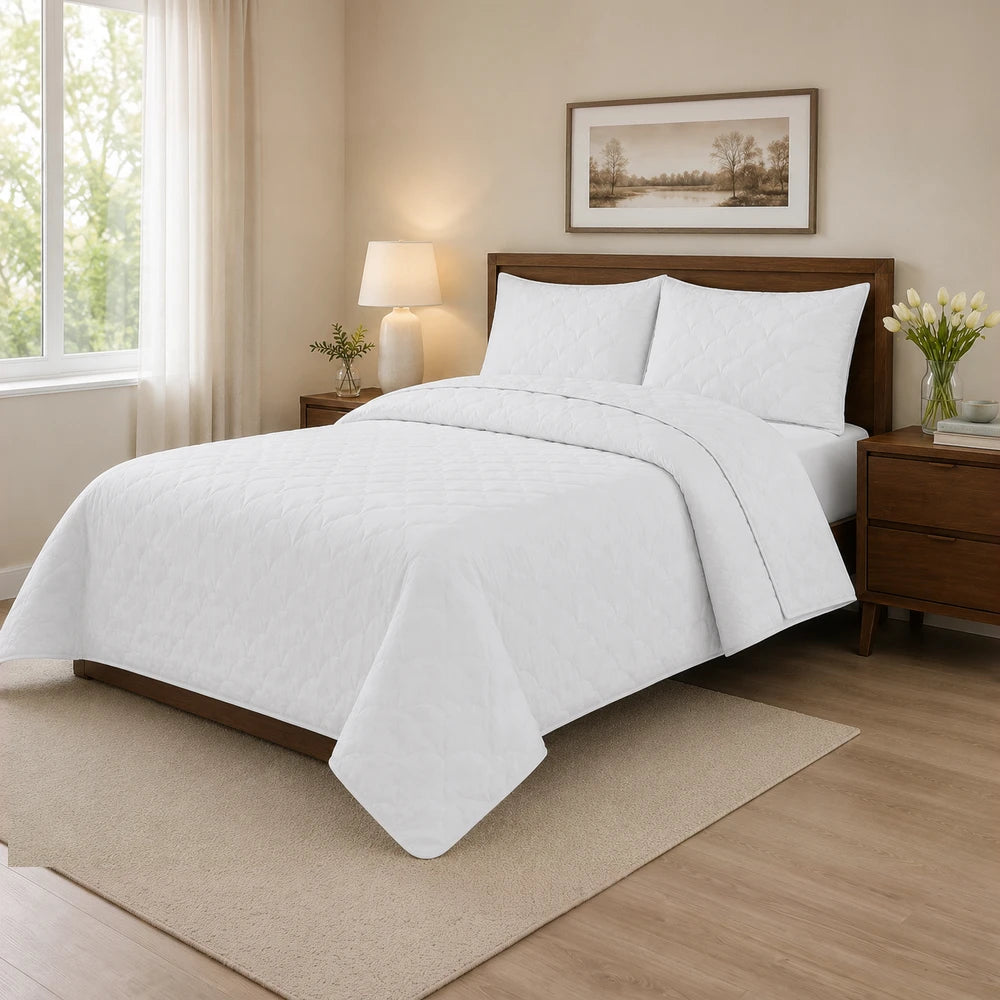 Carducci Washer Quilt Set in white with a quilted diamond pattern on a wooden bed, showcasing a neat, cozy bedroom setup.