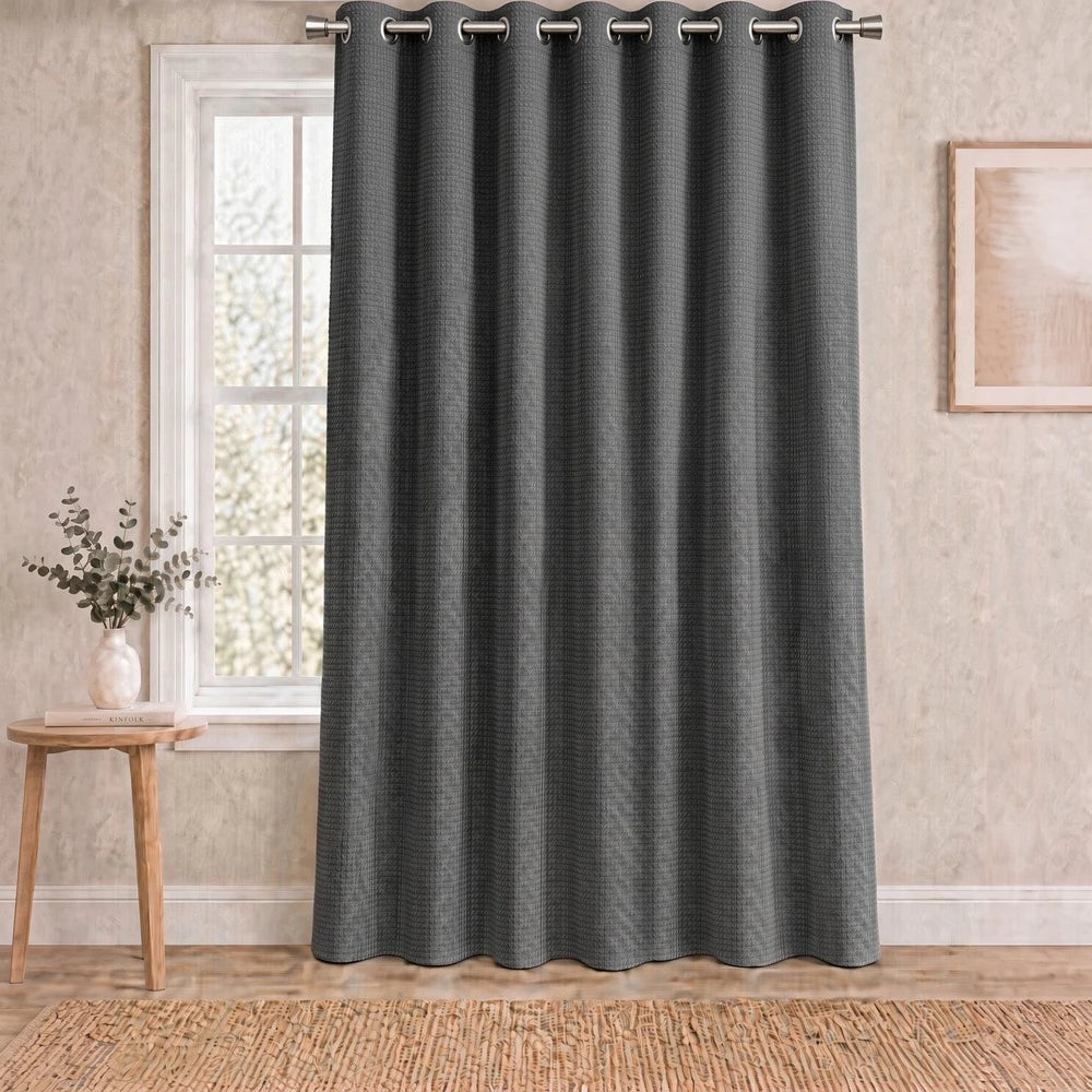 Charlie textured eyelet-lined curtain in dark gray fabric with metal grommets for easy hanging and room-darkening privacy.
