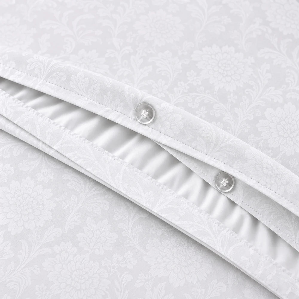 Cotton Co Kate Duvet Cover Set in white with a subtle floral damask pattern and button closure.