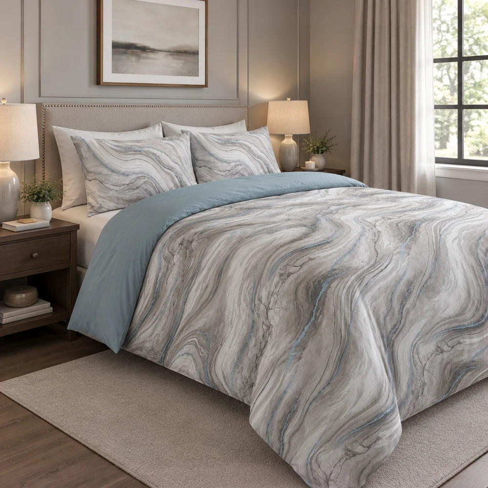 Cotton Co Premium Comforter Set in blue-gray with a marble swirl pattern and a solid blue reverse for a contemporary bedroom
