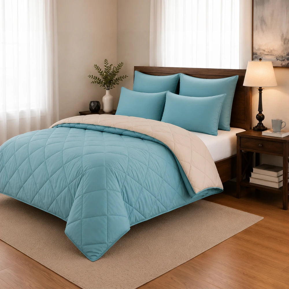 5Pc Pierre Cardin Monochrome Reversible Comforter set in turquoise blue with a beige reverse, shown on a neatly made bed