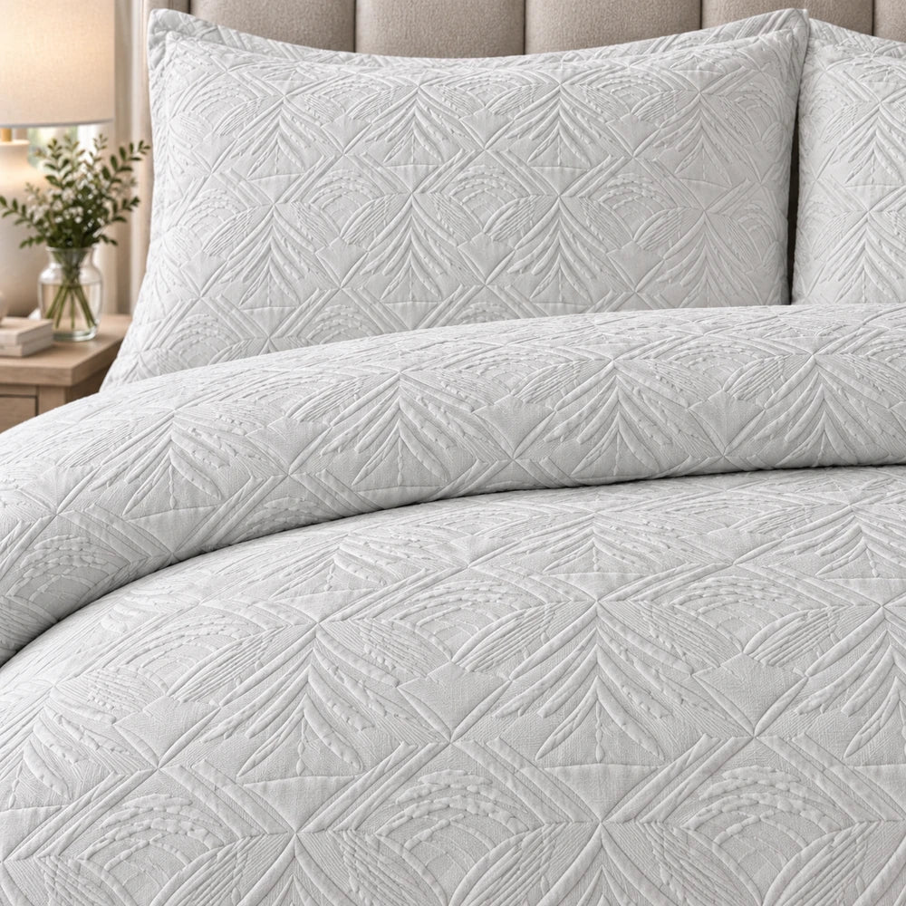 Horrockses 3D embossed palm Jumera duvet cover set in light gray with a quilted palm leaf pattern and matching pillowcases.
