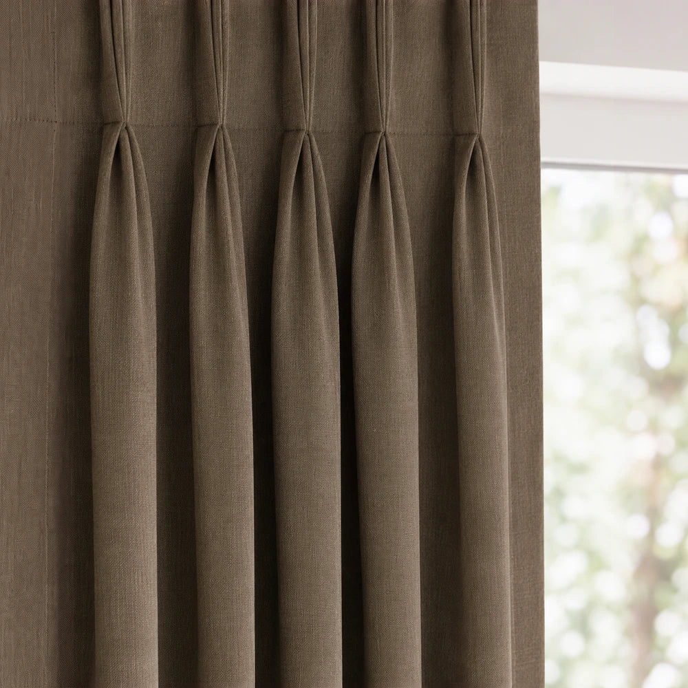 Linen-look unlined taped curtain in warm taupe with gathered header tape and soft vertical drape.
