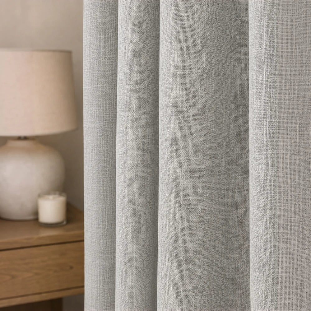 Linen Textured Blockout Curtain in soft grey fabric, close-up of woven texture and full drape.