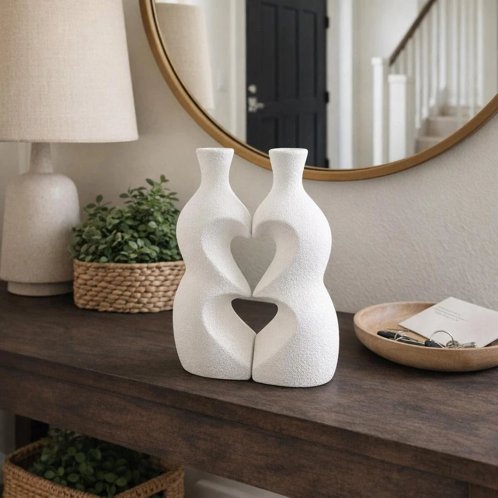 Modern Interlocking Ceramic Vase Set with two white textured vases interlocking to form a heart shape.