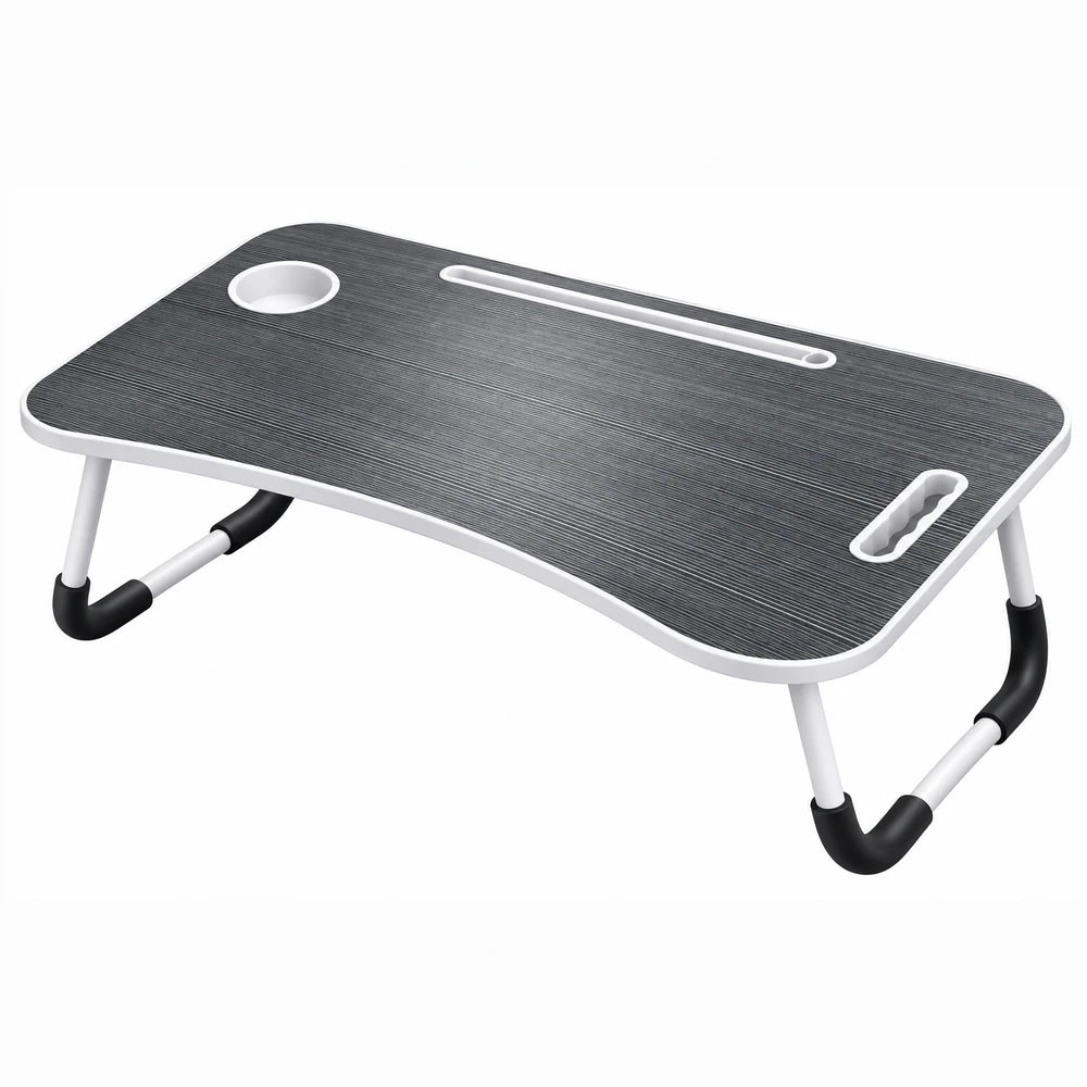 Multi-functional foldable laptop table with black wood-grain surface, white frame, cup holder, and built-in slot for cords.