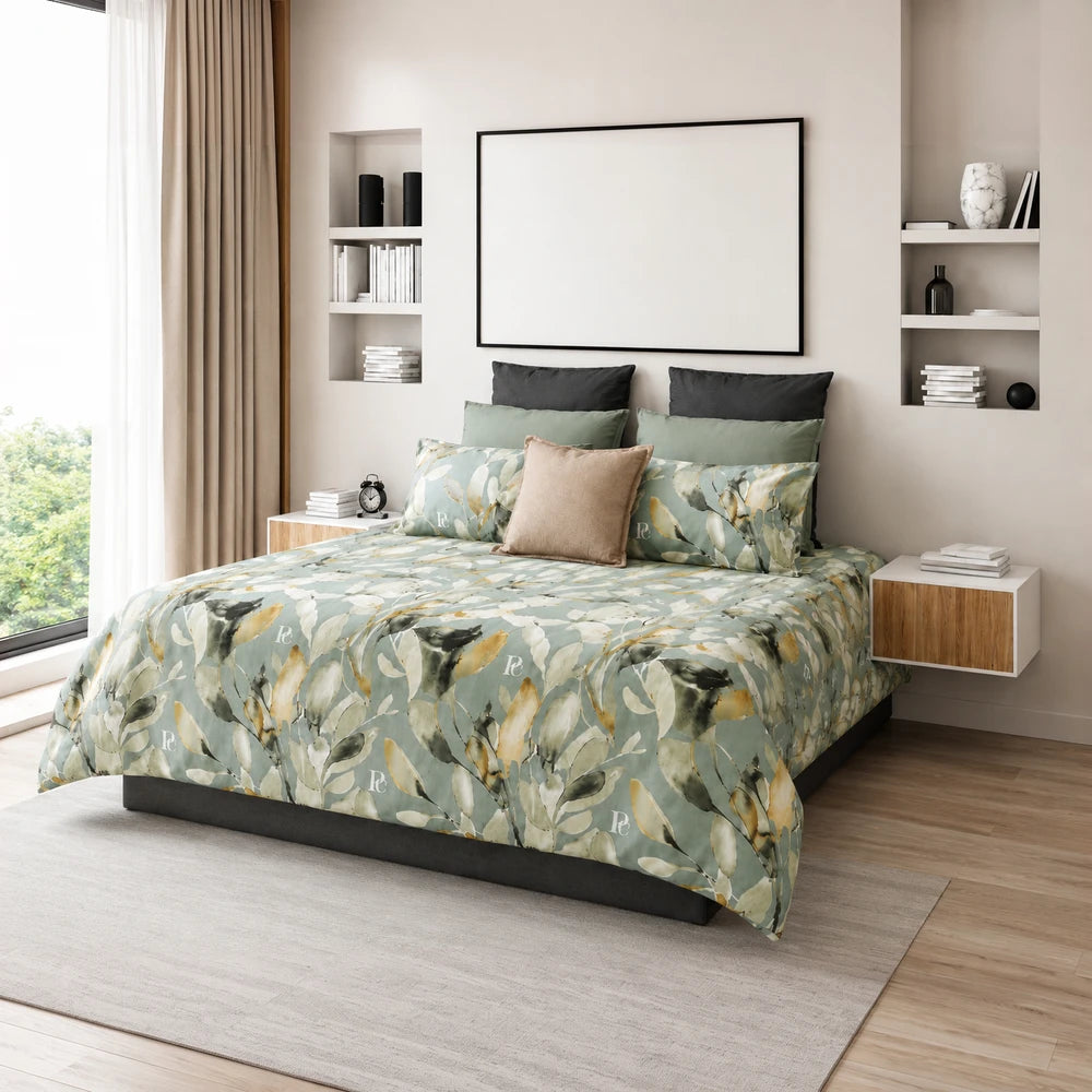 Pierre Cardin Microfibre Duvet Cover Set Aralin Leaves in green and beige with a botanical leaf pattern on the bed.