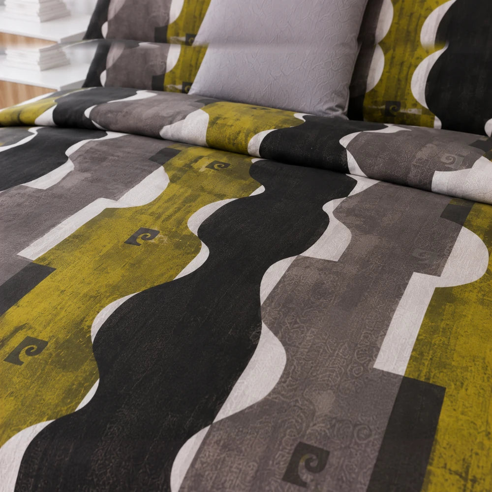 Pierre Cardin microfibre cover set Branson displayed on a bed with an abstract yellow, gray and black pattern