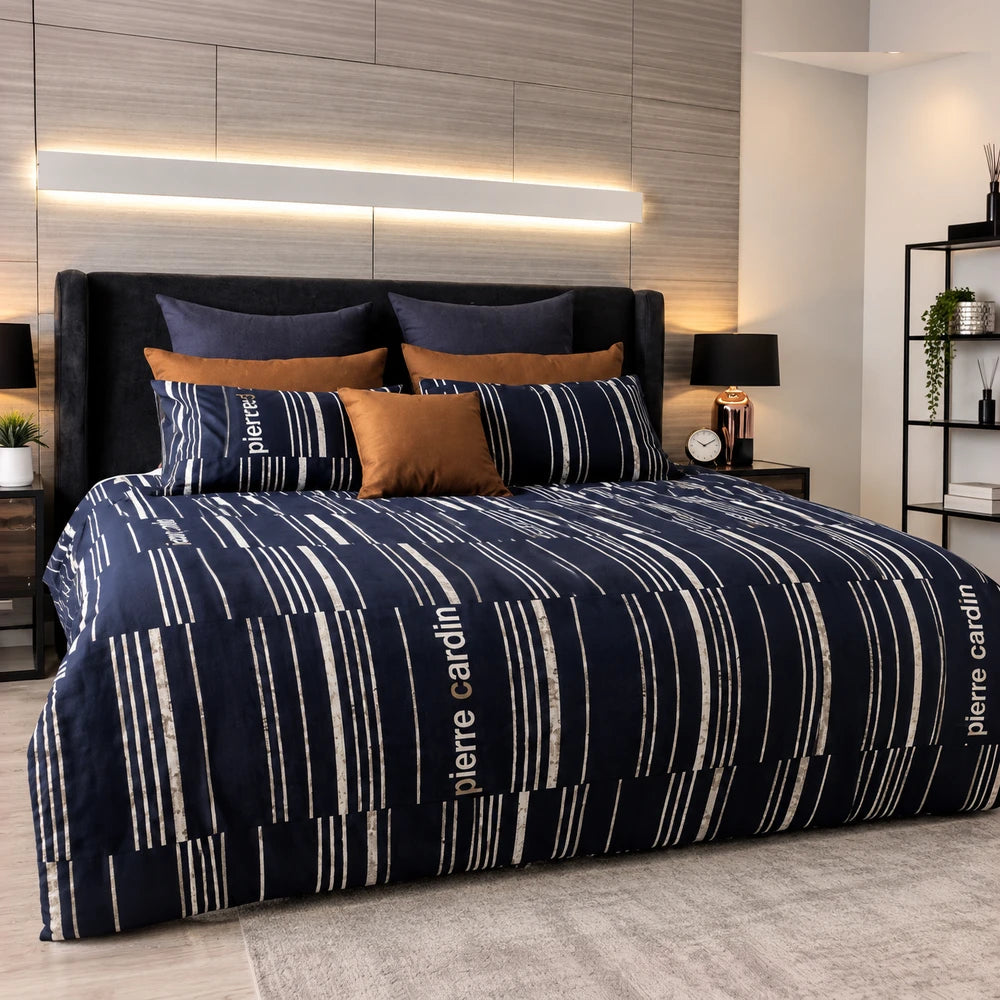 Pierre Cardin Microfibre Duvet Cover Set in navy with white striped pattern and logo, on a neatly made bed.