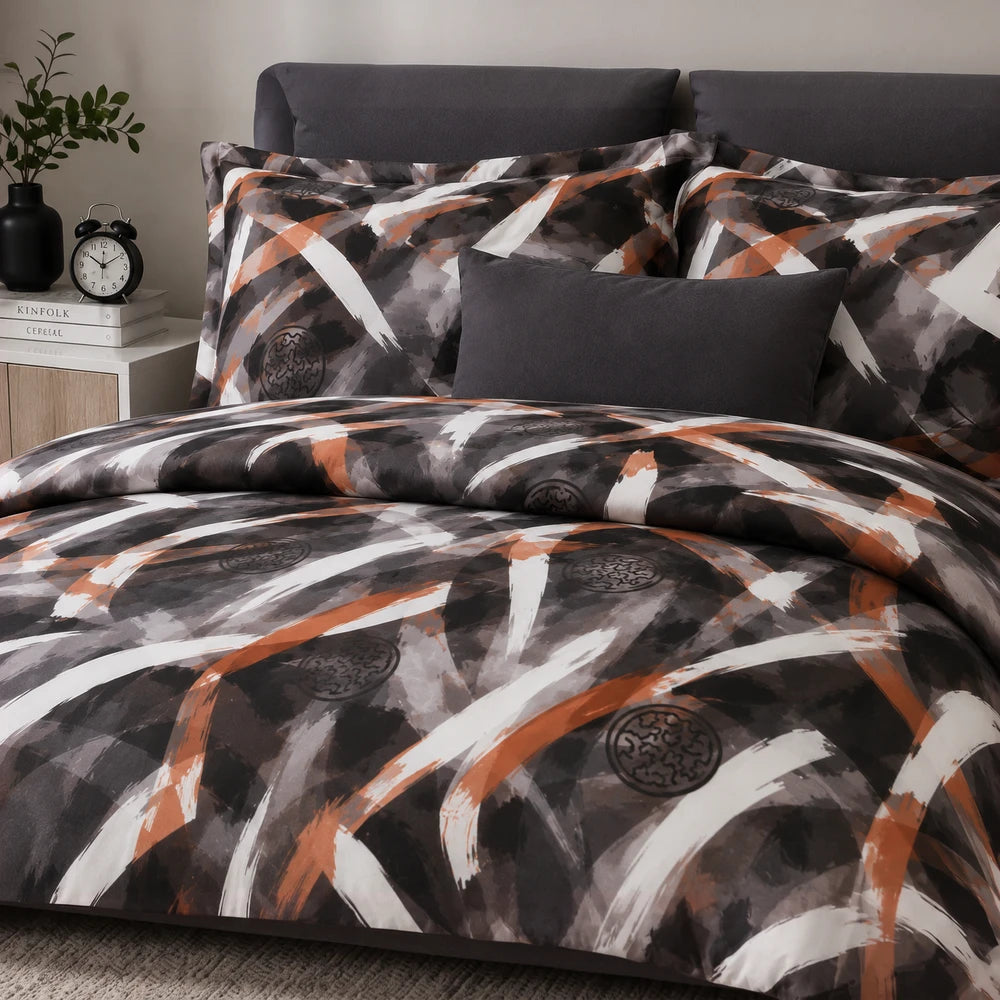 Pierre Cardin Microfibre Duvet Cover Set Reiya in a dark abstract pattern with black, grey and orange brush strokes.