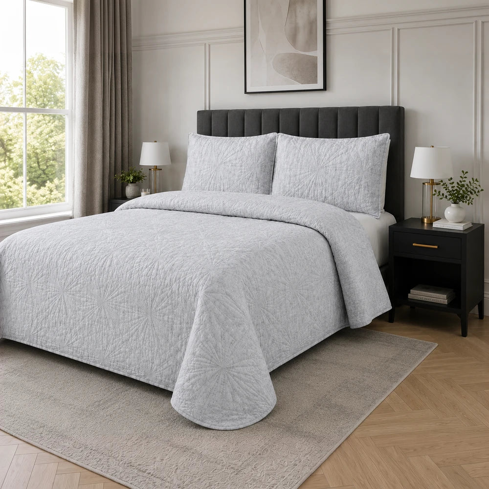 3Pc Pierre Cardin Textured Pinsonic Quilt set in light gray with matching pillow shams on a bed