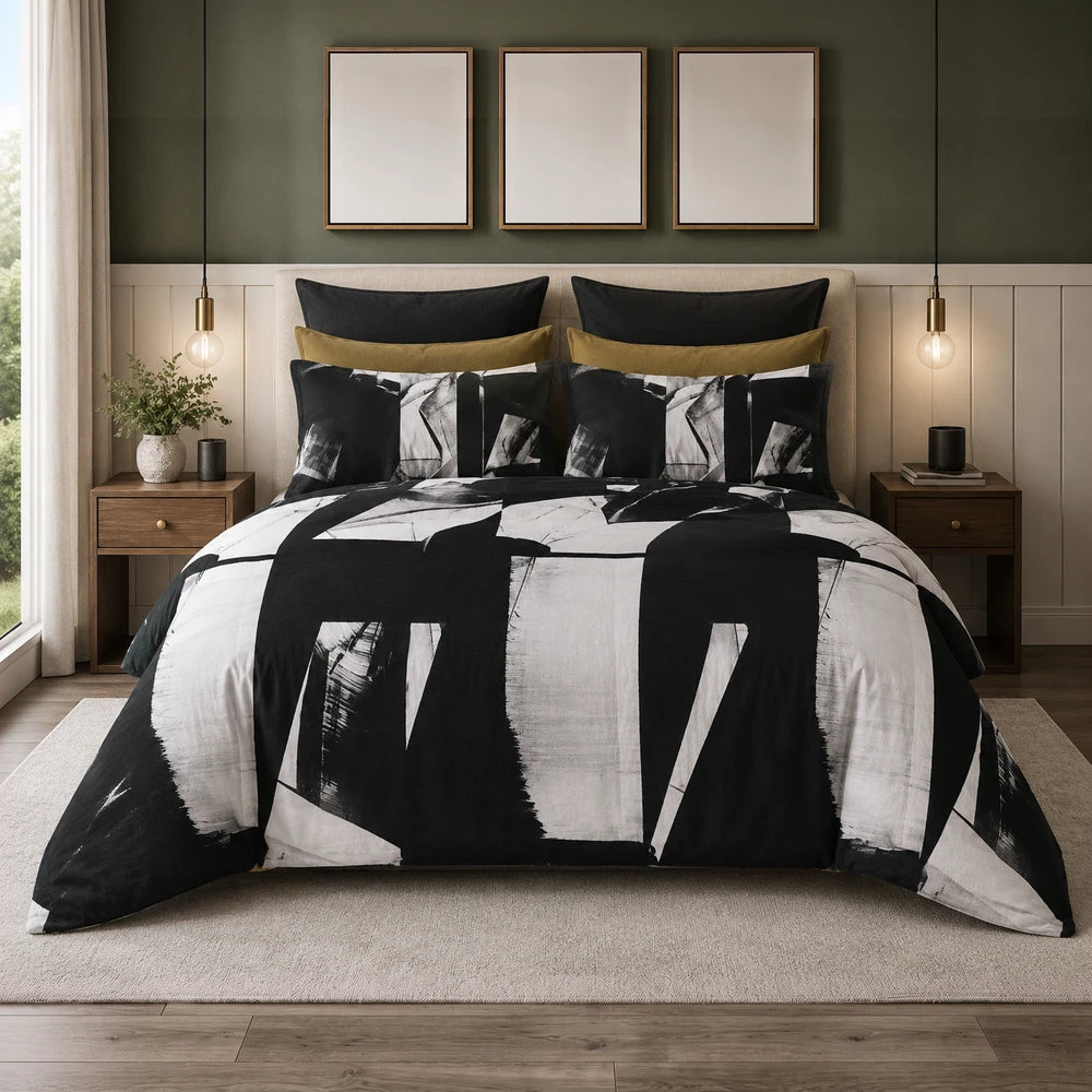 Pierre Cardin Vogue Duvet Cover Set in black and white abstract pattern with coordinating pillow shams on a styled bed.