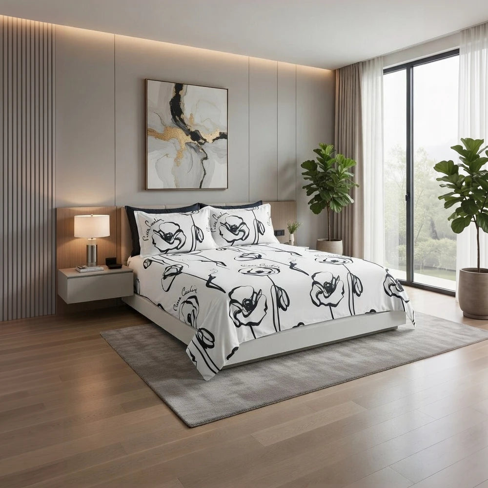 Pierre Cardin Vogue Duvet Cover Set in white with bold black Contempo Bloom floral pattern on bed.