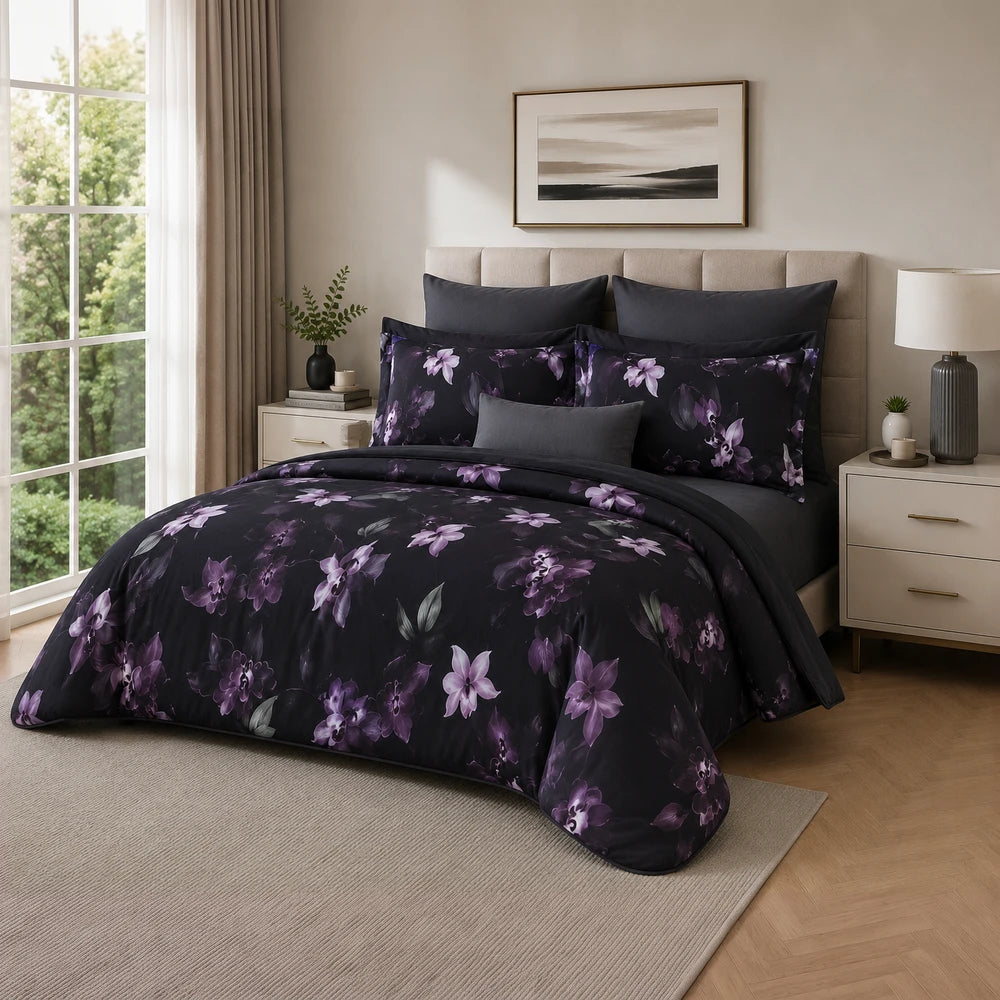 Pierre Cardin Vogue Duvet Cover Set in noir with purple botanical floral pattern, a stylish bedding set for a bed.