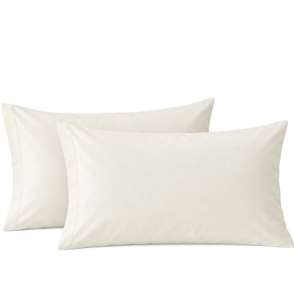Two off-white polycotton standard pillowcases in a 2-pack, displaying their soft fabric texture and stitched edges.