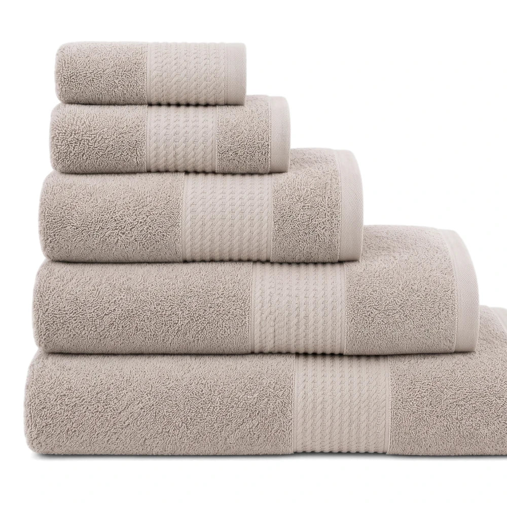 Stacked beige premium 100% cotton 450GSM towels, showing various bath, hand, and washcloth sizes with terry texture.
