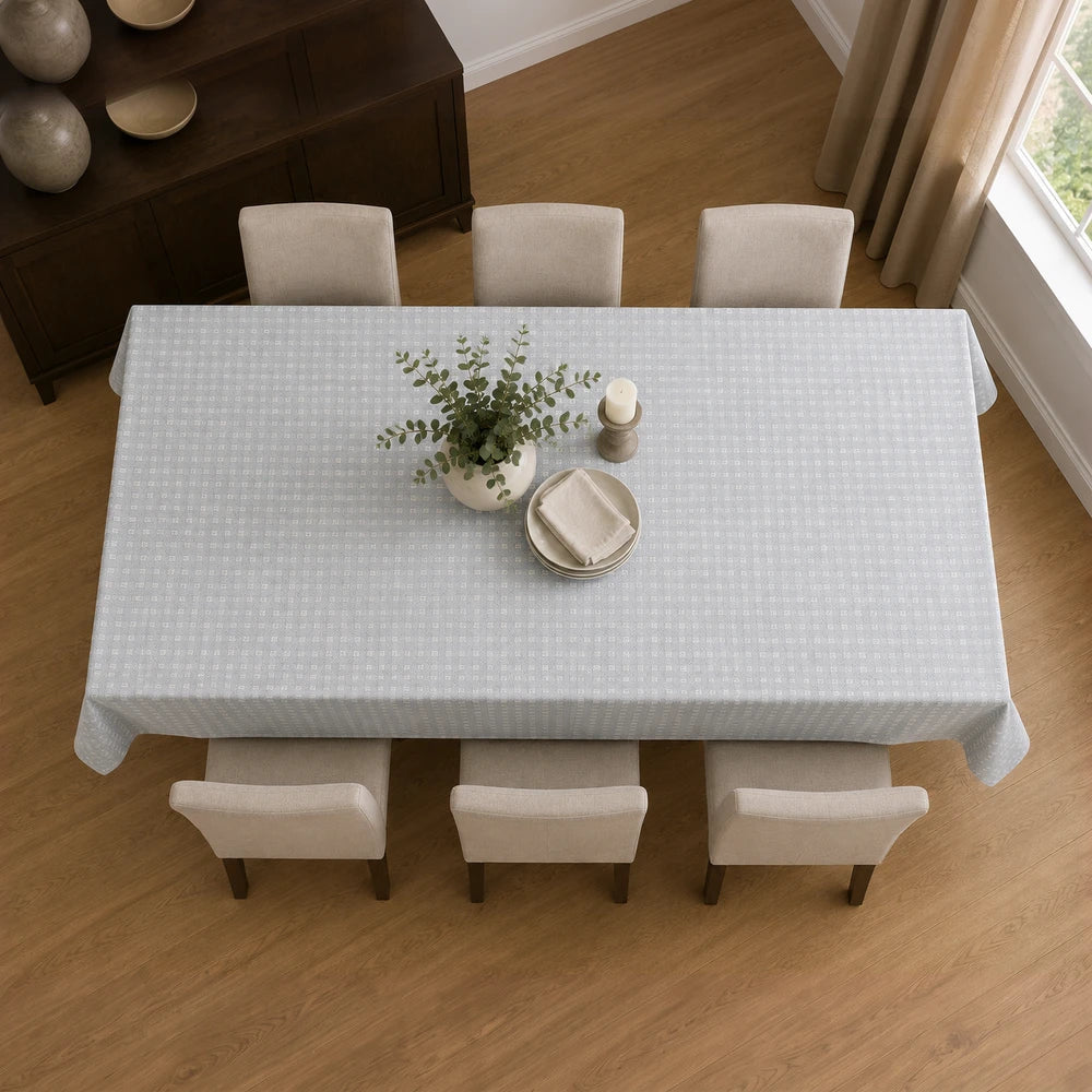 Premium 4-6 seater Charlie textured tablecloth in light blue with a subtle geometric pattern on a dining table.