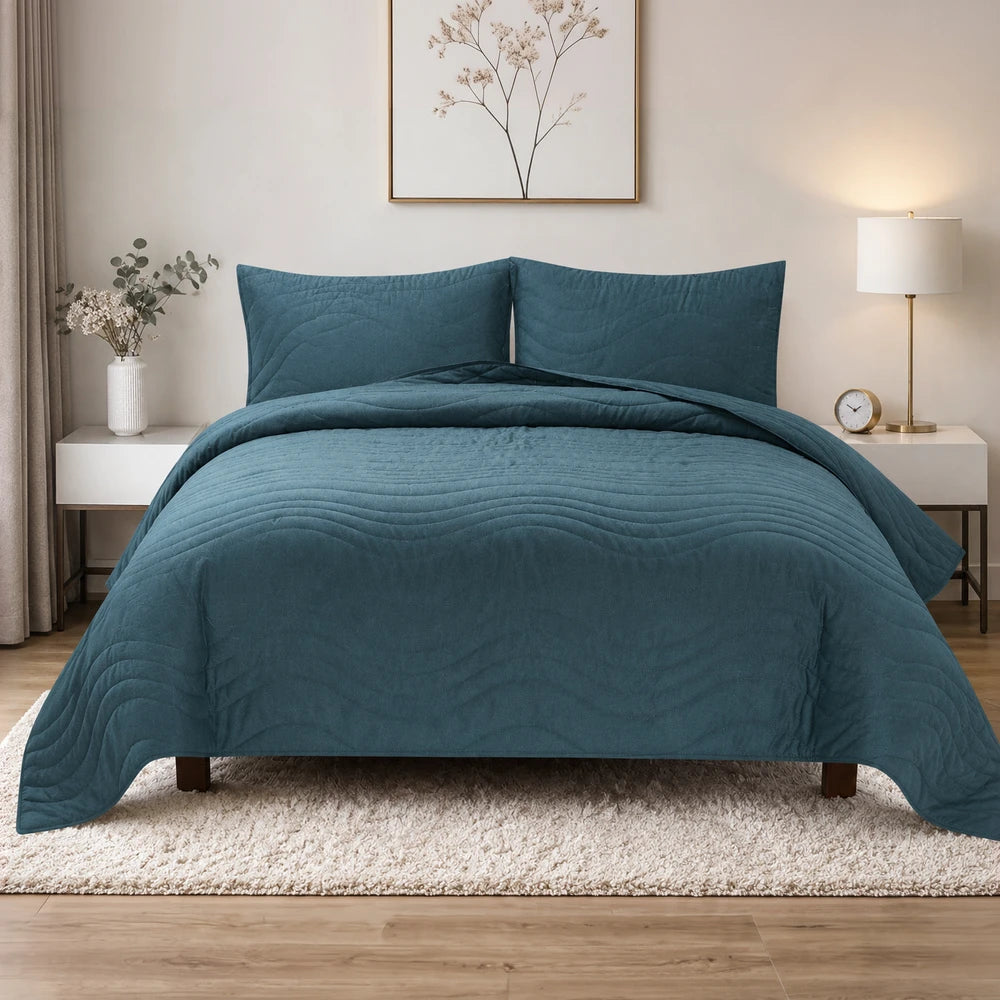 Premium Carducci wave pattern 100% cotton quilt in teal blue with a quilted wave design for a cozy bed setup.