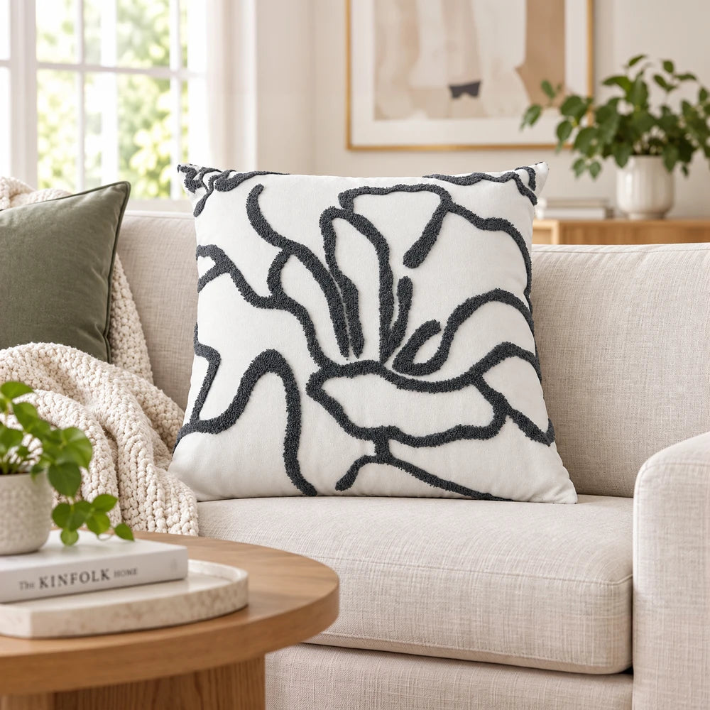 Premium polycotton scatter cushion cover in white with a black textured abstract pattern, shown on a beige sofa.