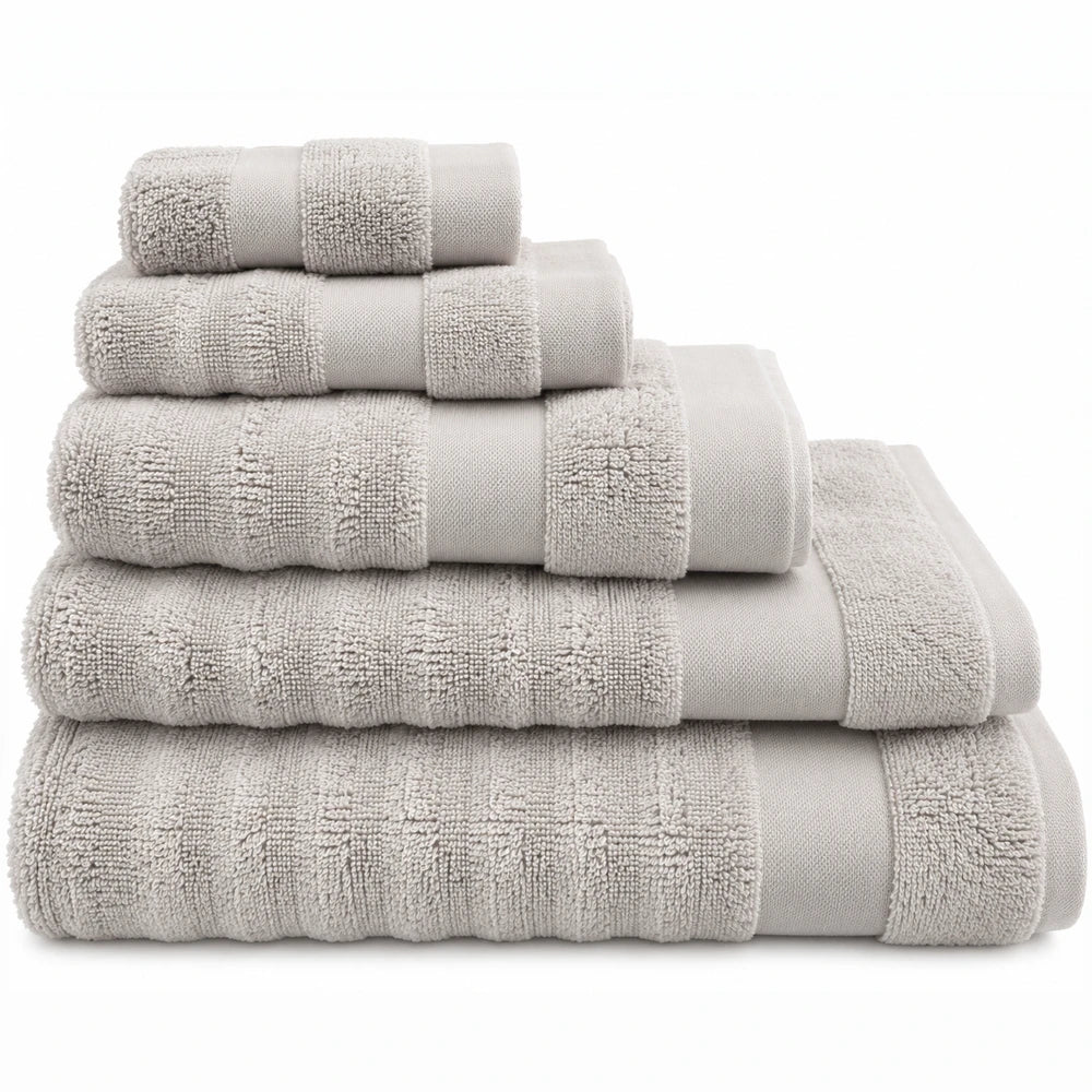Premium ribbed zero-twist cotton towels in beige, 500GSM, stacked to show hand, bath, and guest towel sizes.