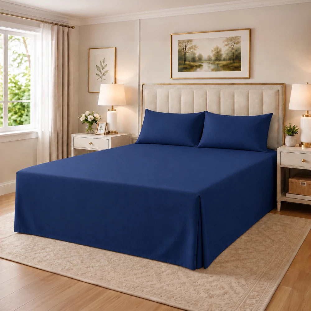 Tela Milano Easy Fit Combo navy blue bed sheet set with fitted sheet and two pillowcases on a neatly made bed.