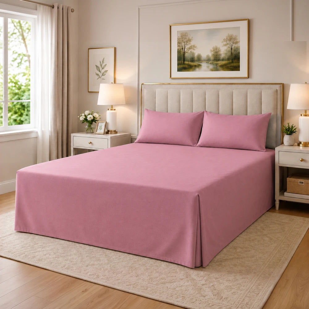 Tela Milano Easy Fit Combo pink bed set with matching pillowcases on an upholstered beige bed.