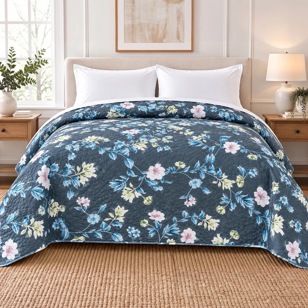 Ultrasonic 1-Piece Printed Quilt in dark blue with blue, pink, and green floral pattern—220 x 200 cm on a bed.