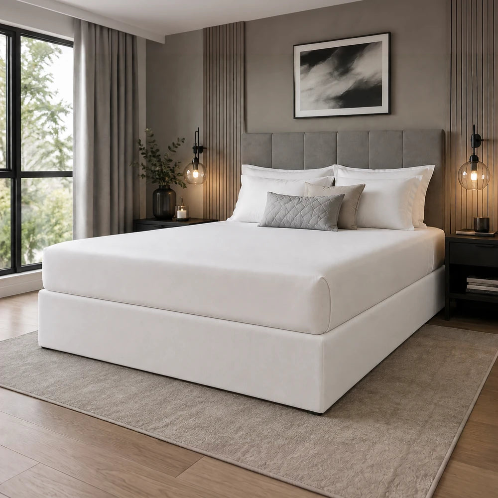 Whisper Soft Microfibre Bedwrap on a white bed with a padded headboard in a modern bedroom.