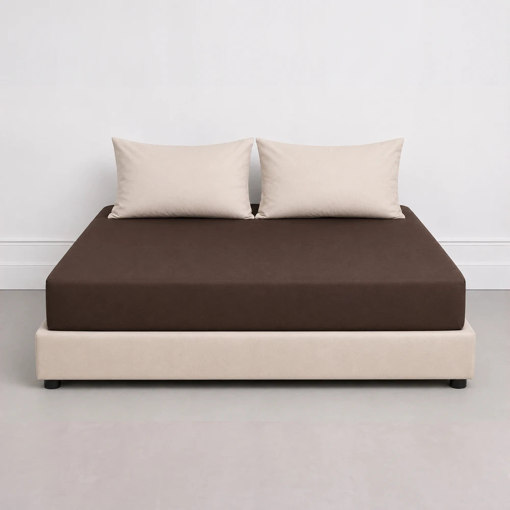 Whisper Soft Microfibre Fitted Sheet in chocolate brown shown on a bed with beige pillows, smooth and snug fit.