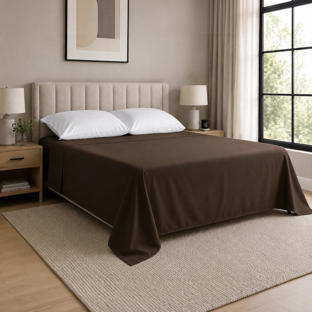 Whisper Soft Microfibre Flat Sheet in deep brown on a neatly made bed with white pillows and a beige headboard.