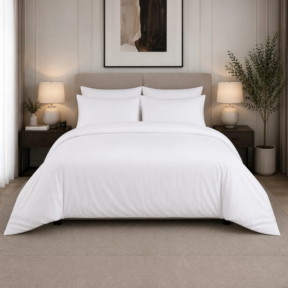White 200TC 100% cotton percale plain duvet cover set on a neatly made bed with white pillows.
