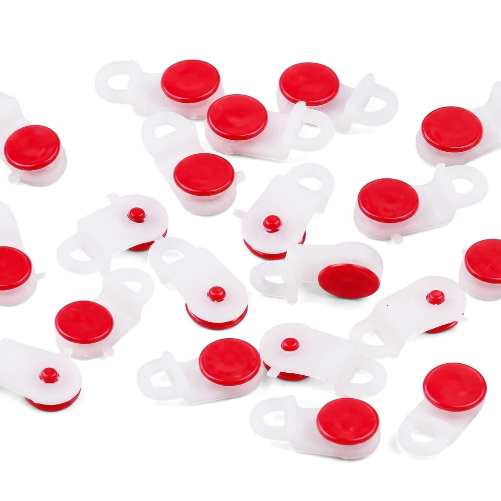 Multiple white plastic curtain wheel runners with red push-buttons, designed for smooth curtain operation.