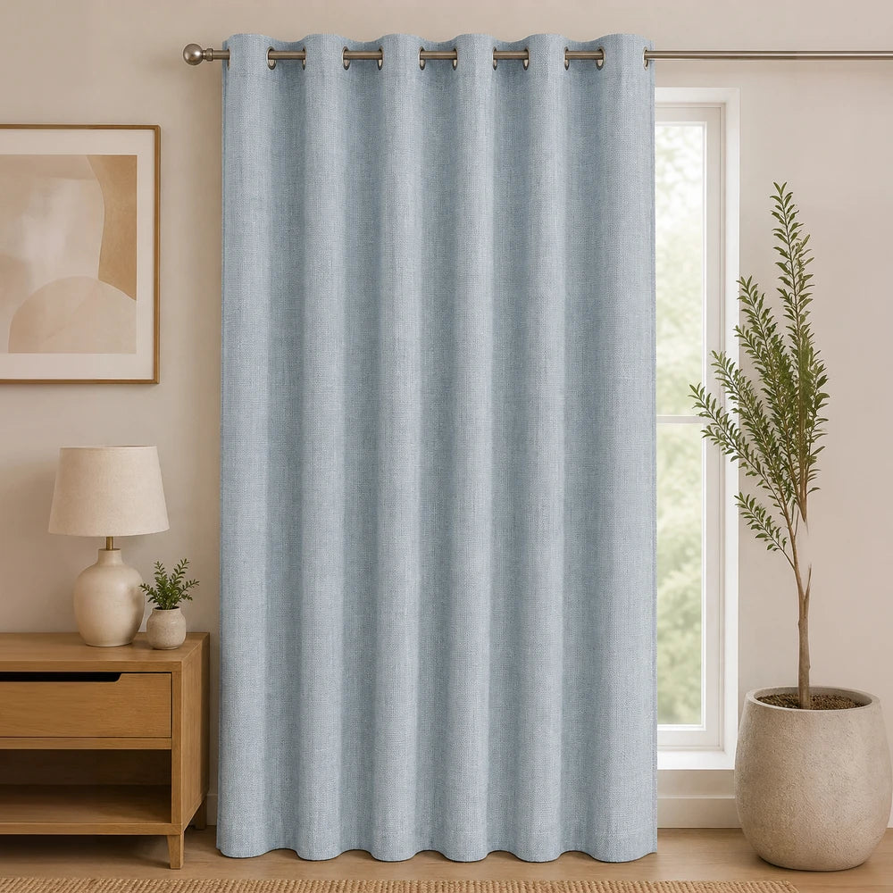 Woven Athens textured eyelet unlined curtain in light blue with metal grommets, showcasing soft fabric and full-length drape.